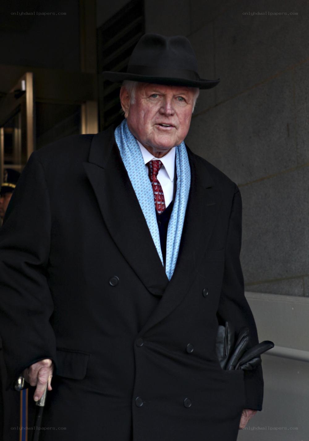 man in black coat and hat