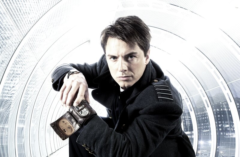 man in black coat holding device