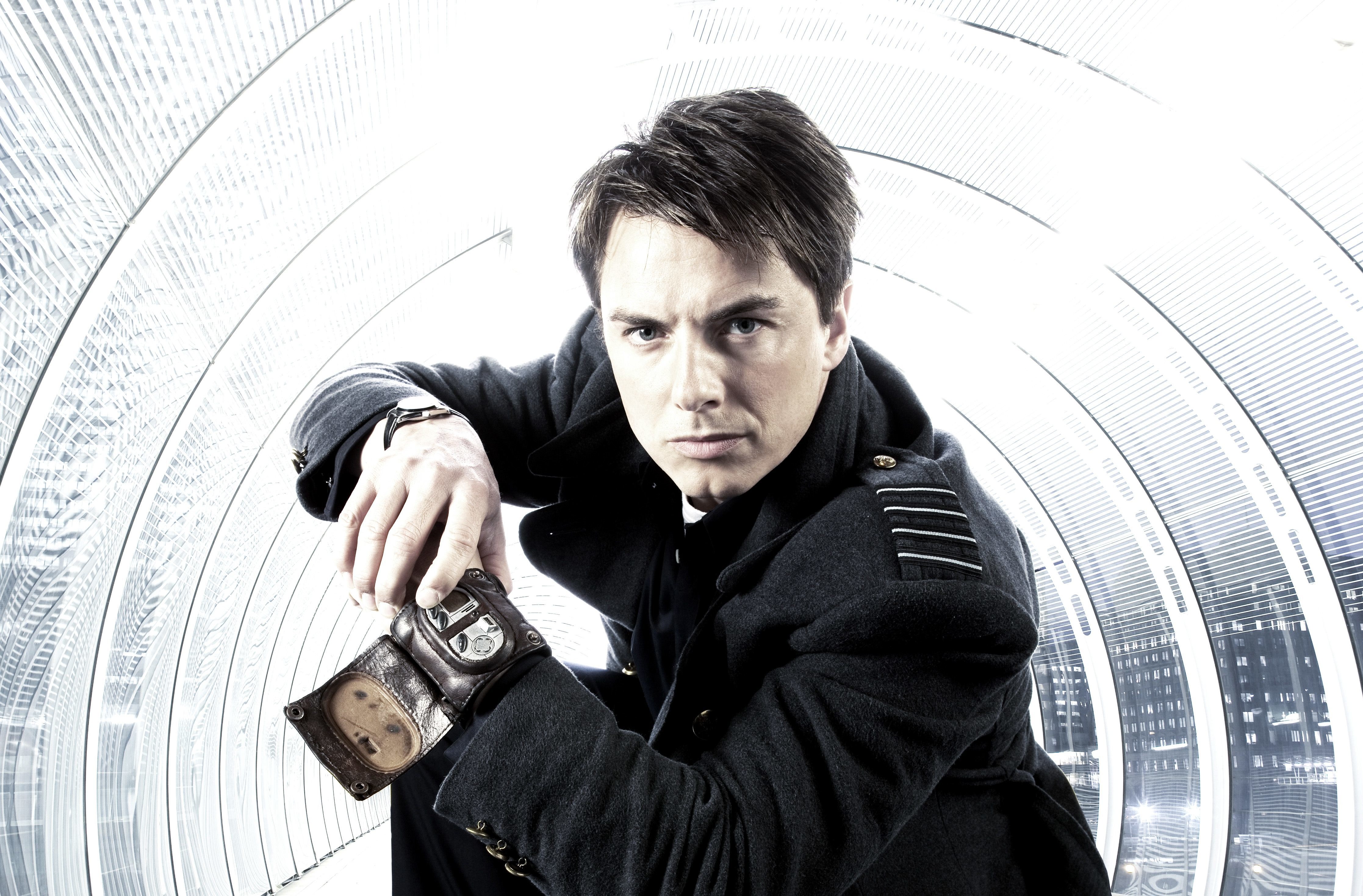 man in black coat holding device