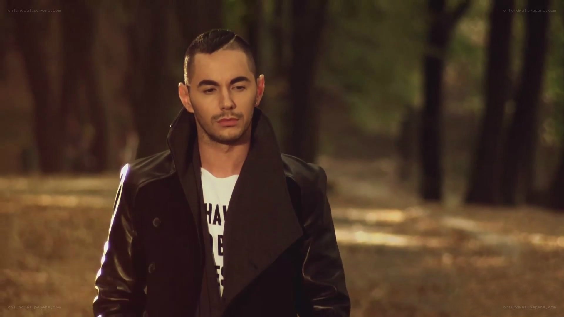 man in black coat in forest