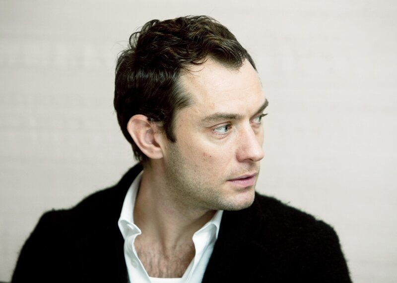 man in black coat looking away