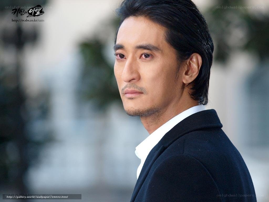 man in black coat looking away