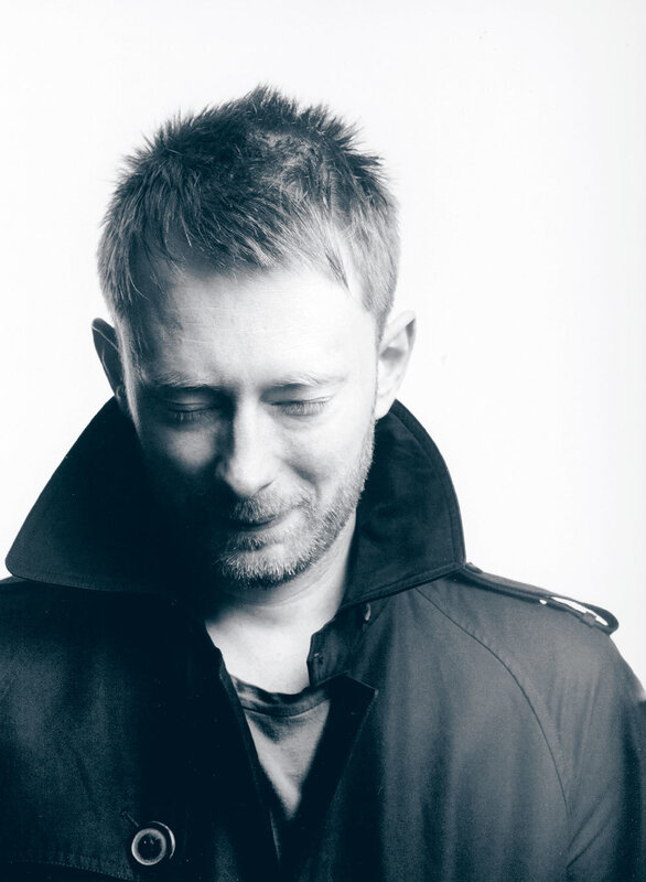 man in black coat looking down