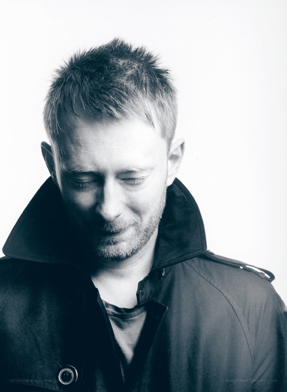 man in black coat looking down