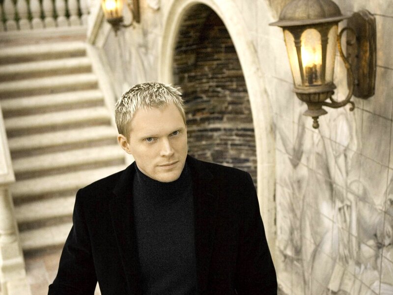 man in black coat on stairs