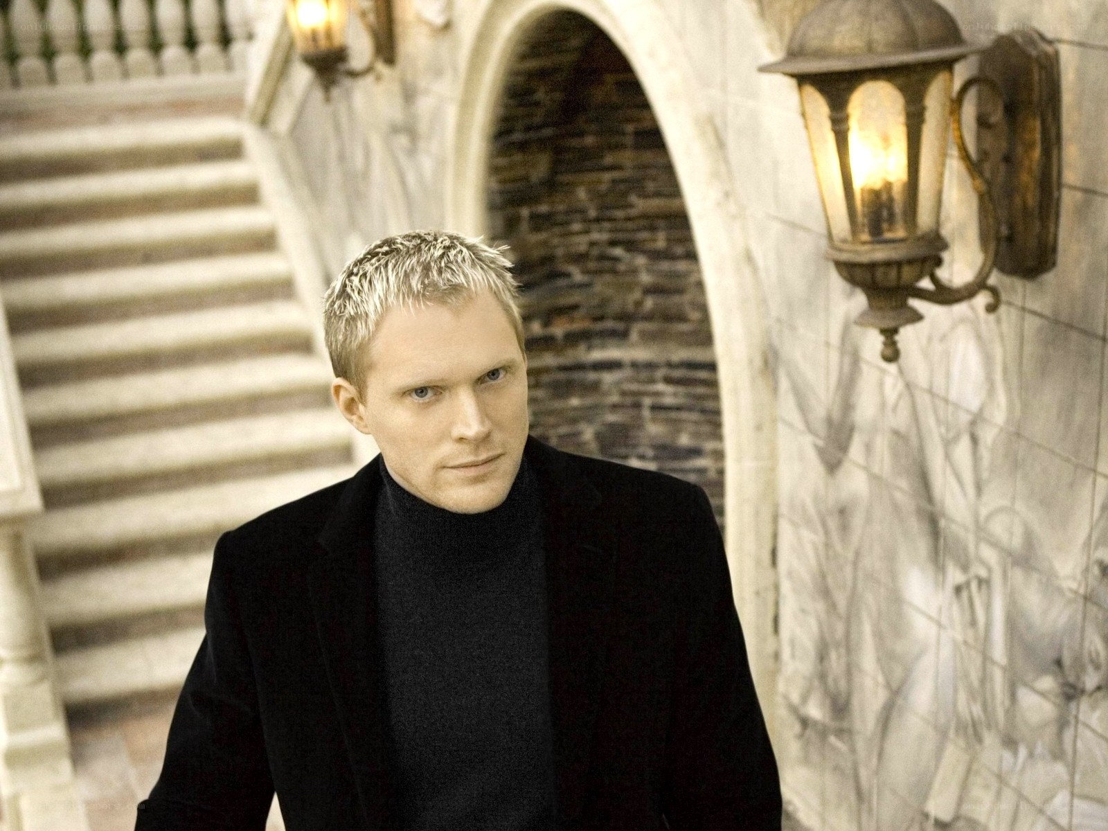 man in black coat on stairs