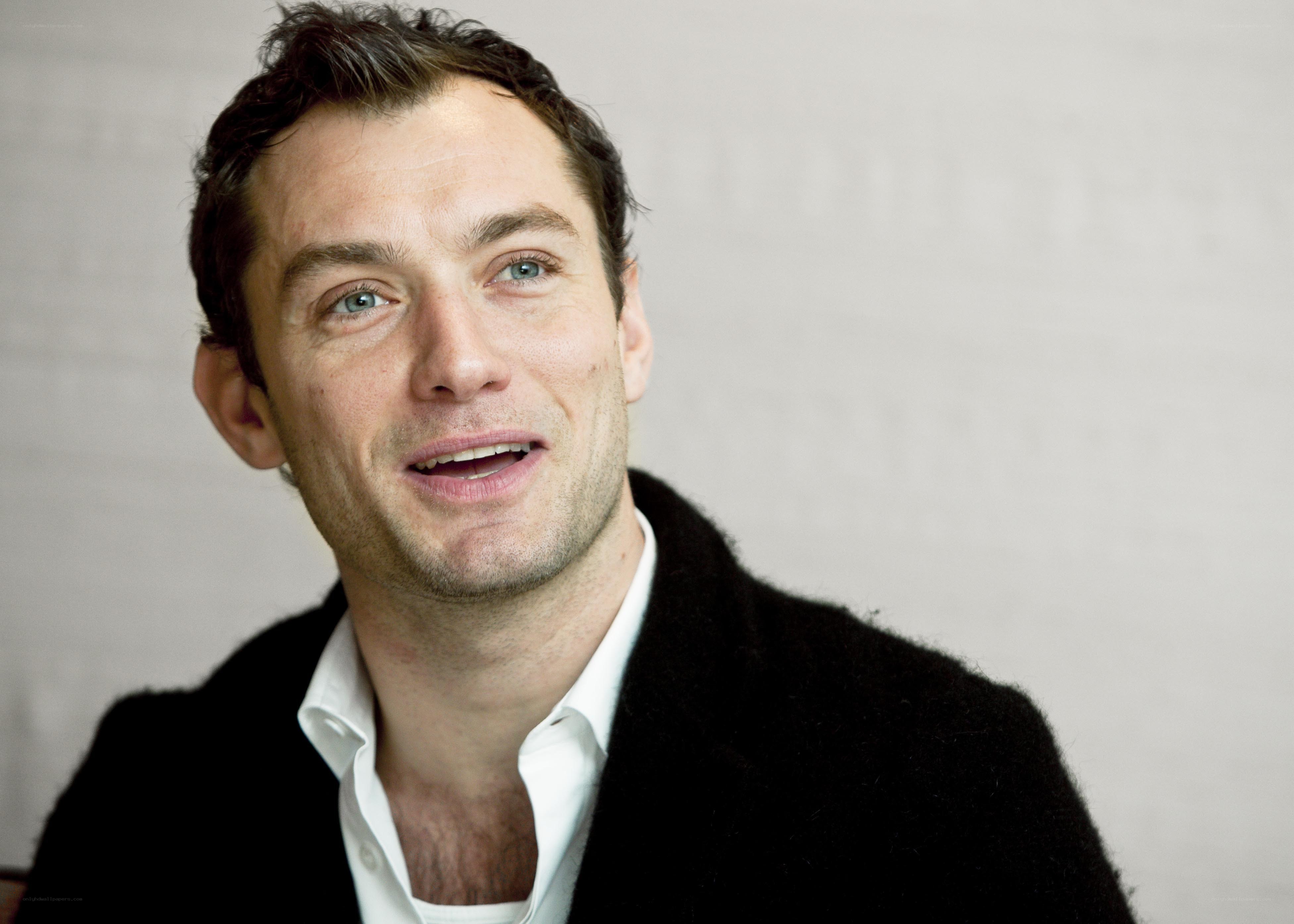 man in black coat smiling