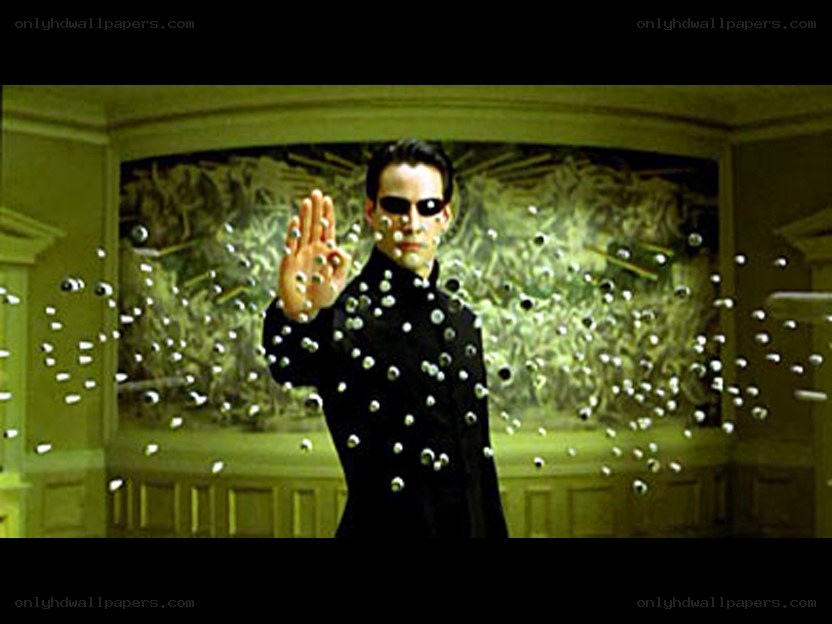 man in black coat stopping bullets