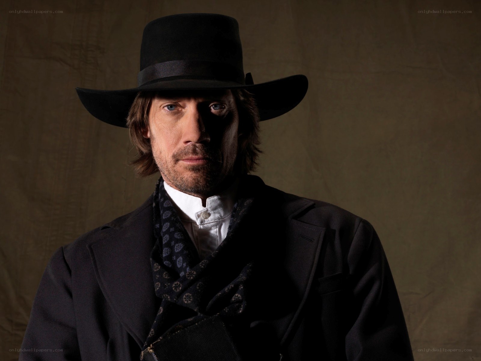 man in black hat and coat