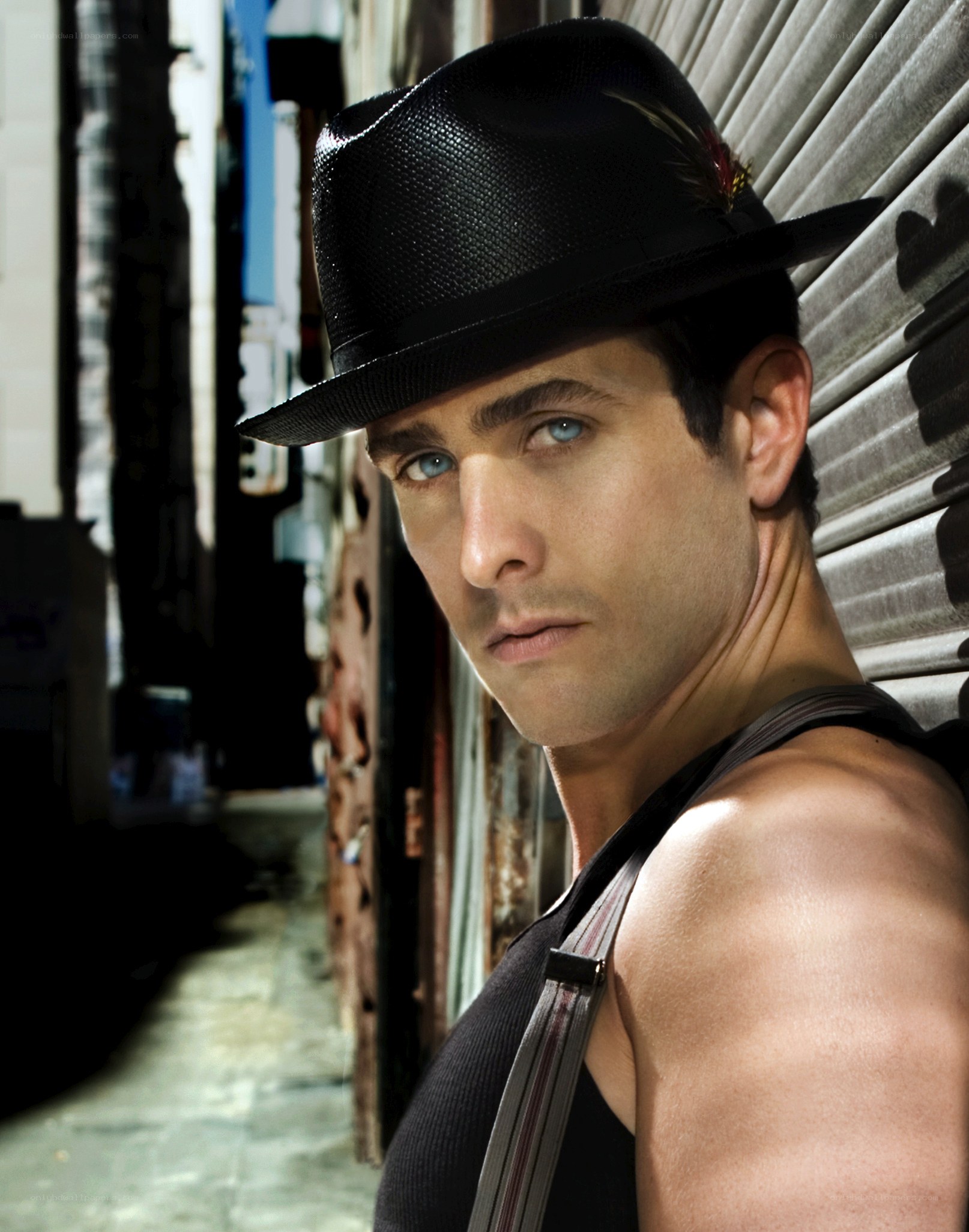 man in black hat and tank top