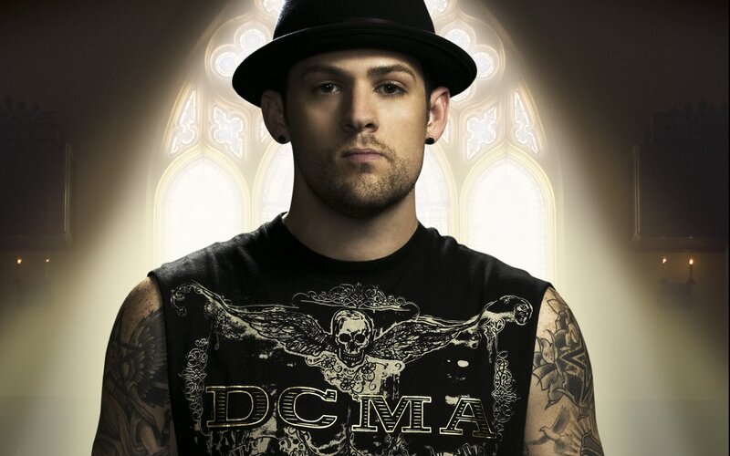 man in black hat with tattoos