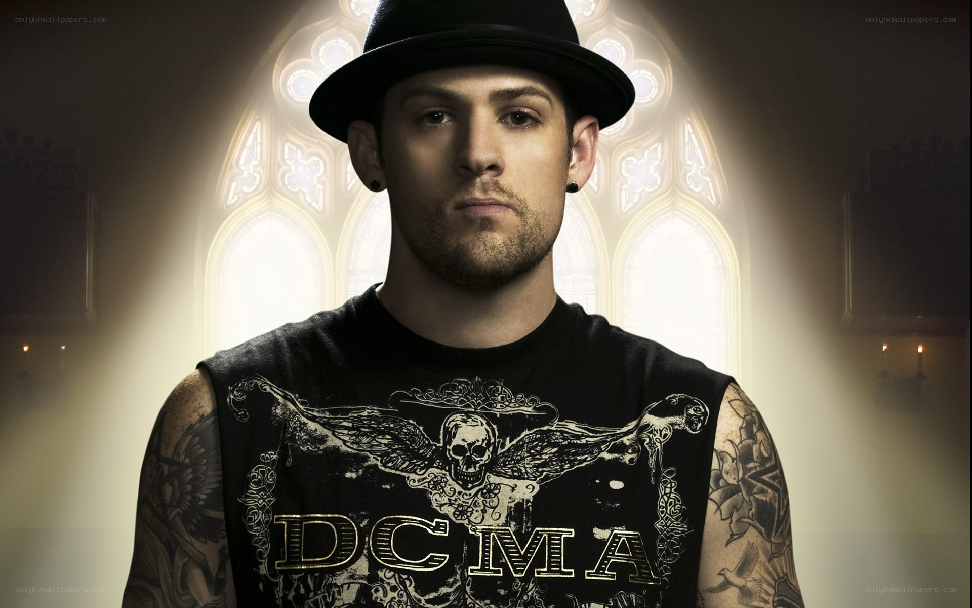 man in black hat with tattoos