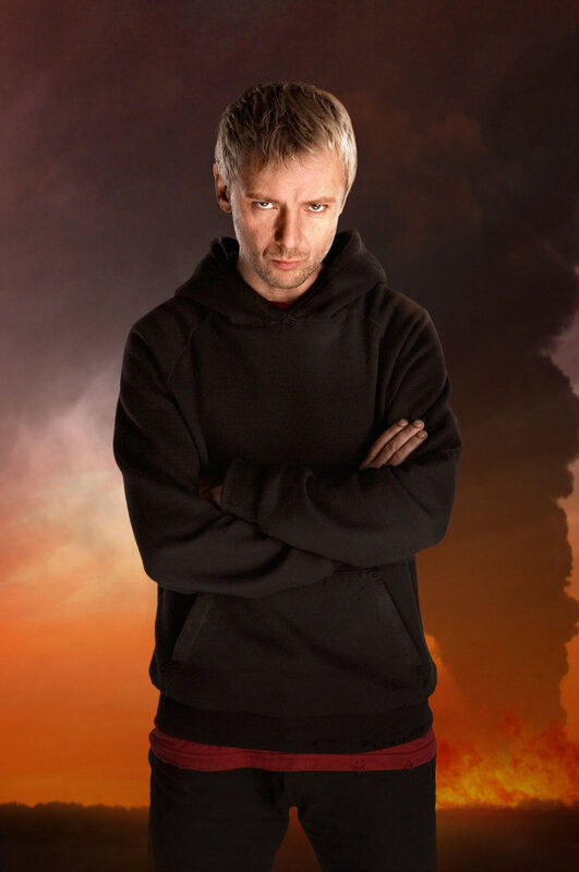 man in black hoodie against fiery sky