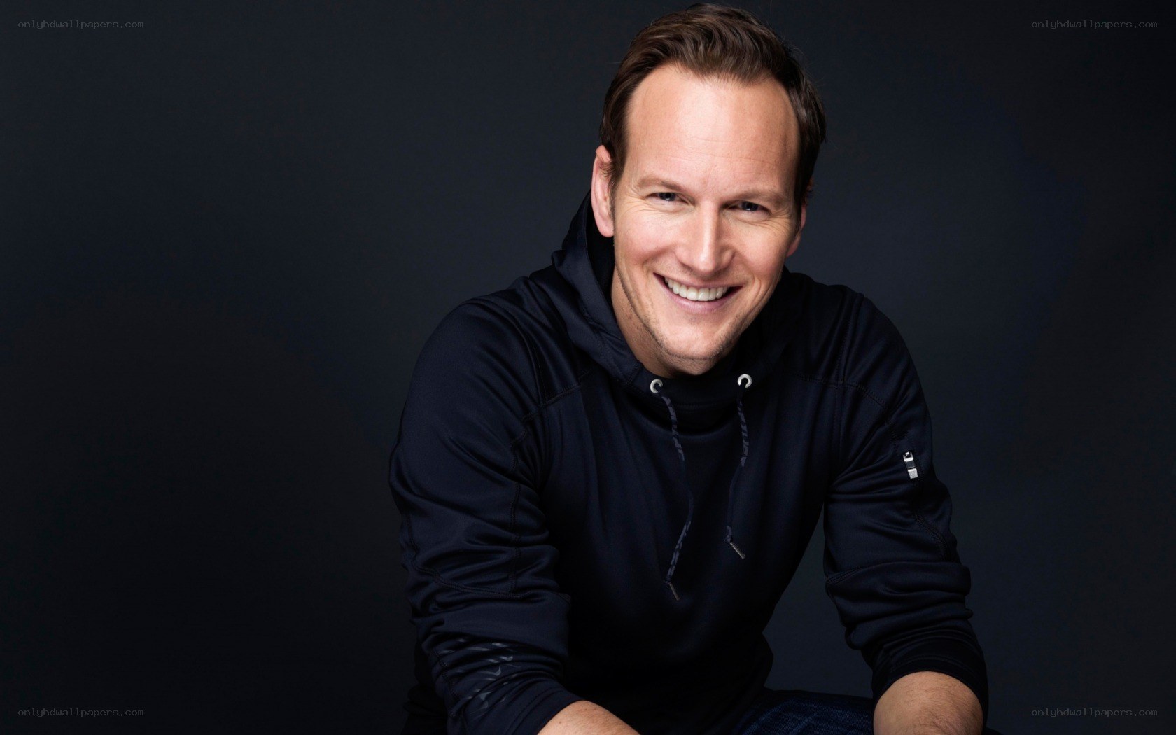 man in black hoodie smiling
