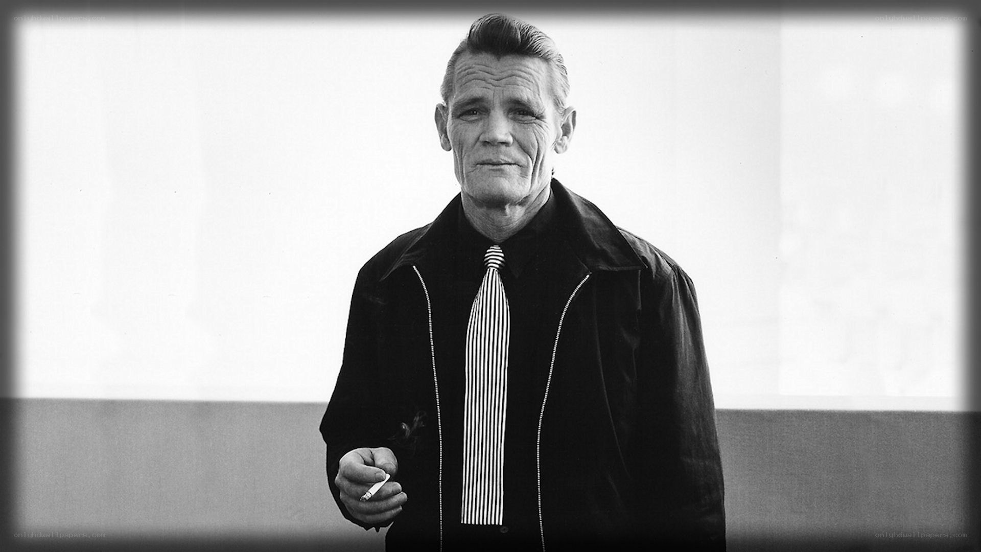 Man in black jacket holding cigarette