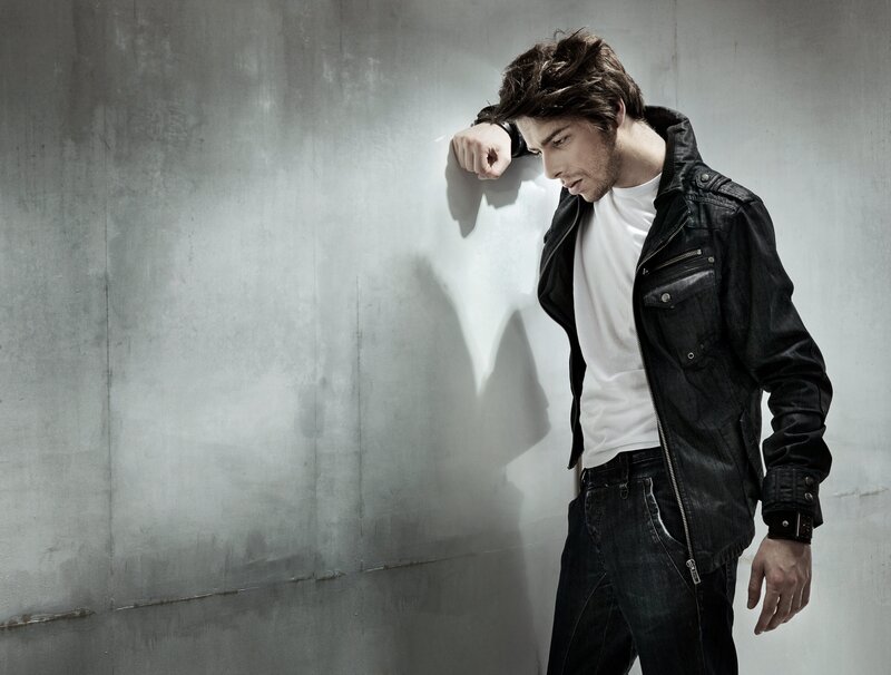 man in black jacket leaning