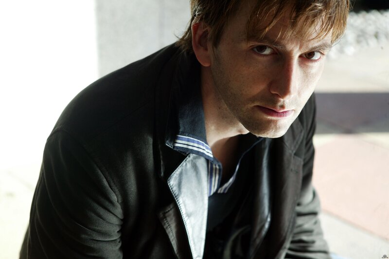 man in black jacket looking down