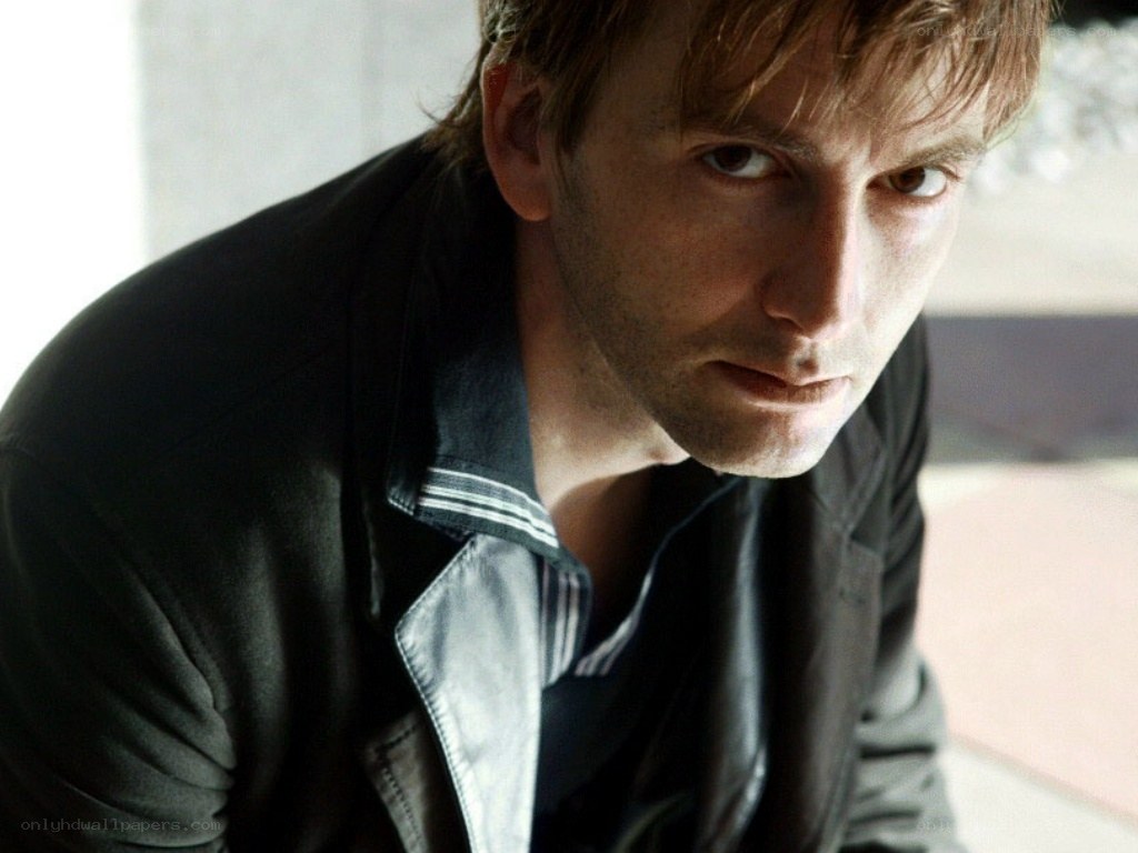 man in black jacket looking down
