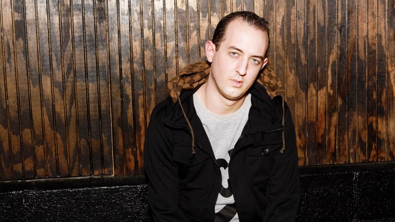 Man in Black Jacket — Neutral, Photograph, Wooden Wall
