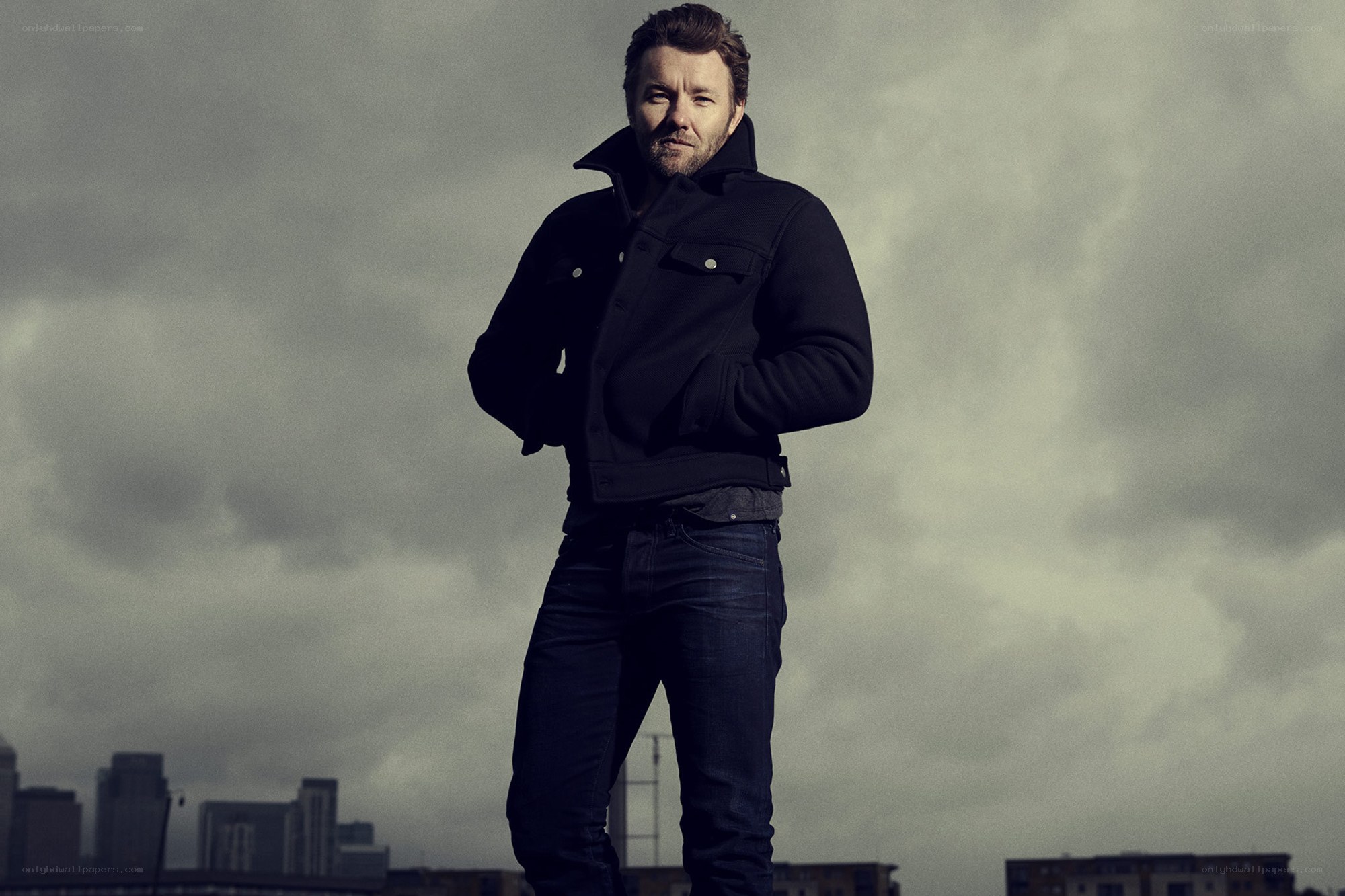 man in black jacket on rooftop
