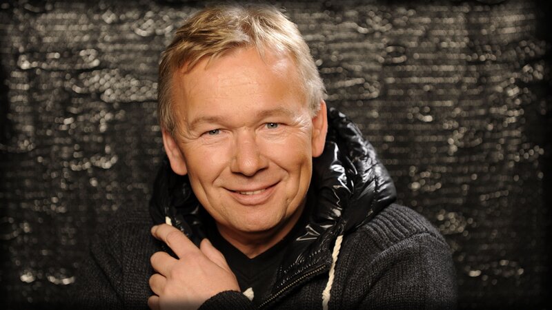 man in black jacket smiling