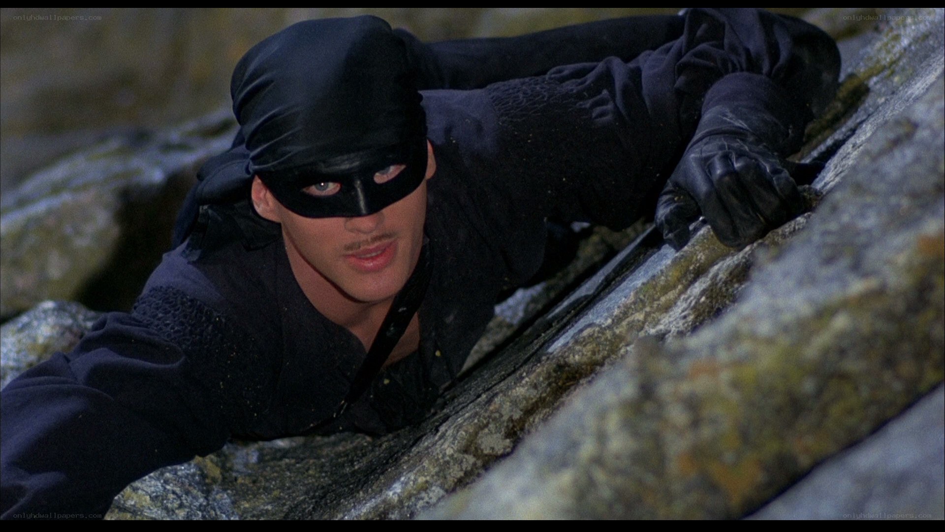 man in black mask climbing
