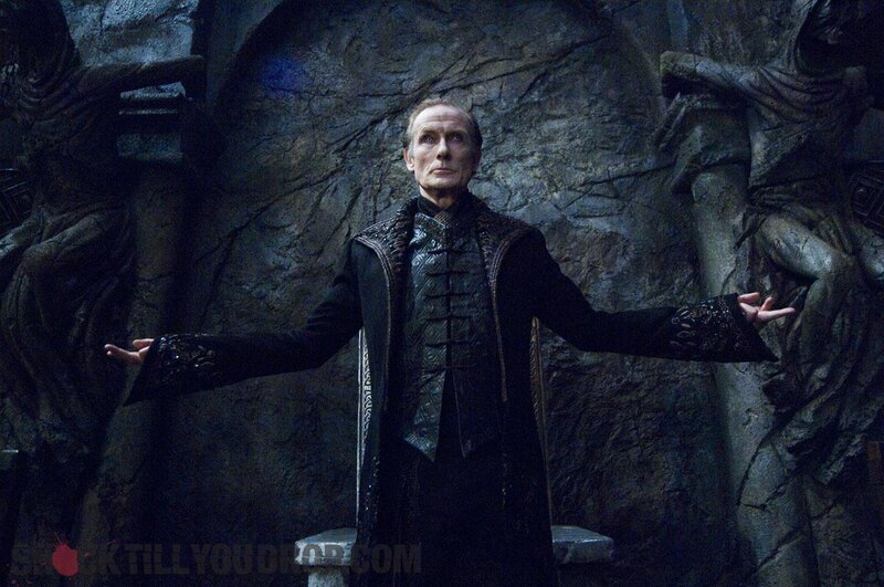 man in black robe with arms outstretched