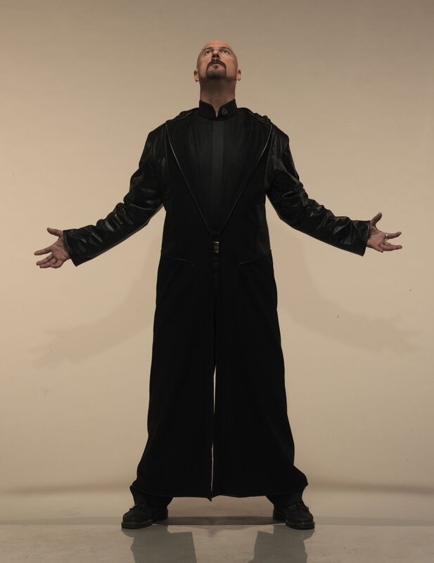 Man in black robe with arms outstretched