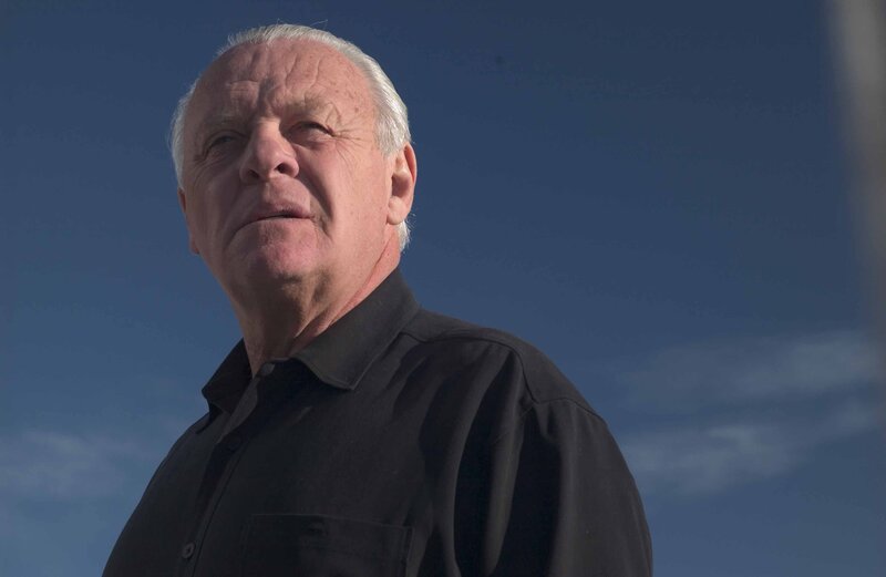 man in black shirt against blue sky