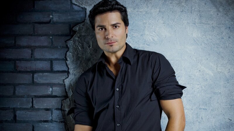 man in black shirt against brick wall