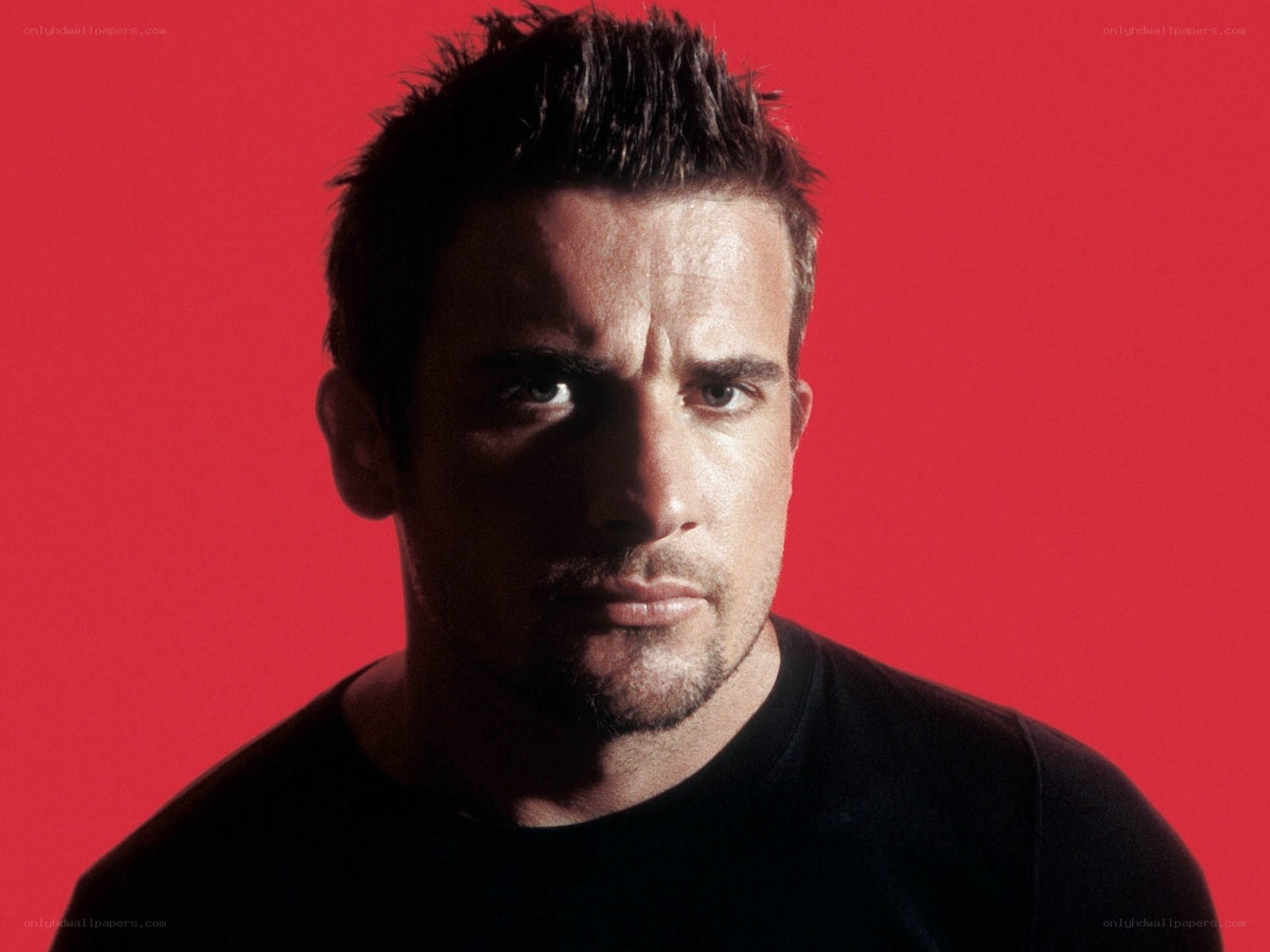 man in black shirt against red