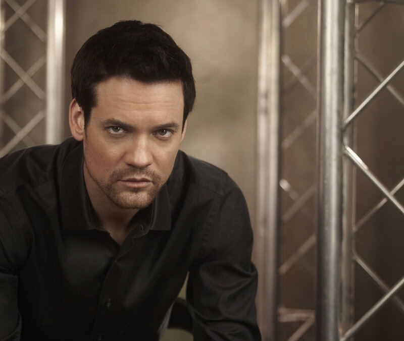 Man in Black Shirt — Serious, Photograph, Metal Truss