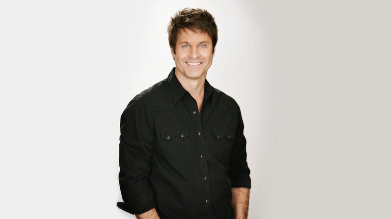 man in black shirt smiling