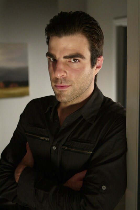 man in black shirt with arms crossed