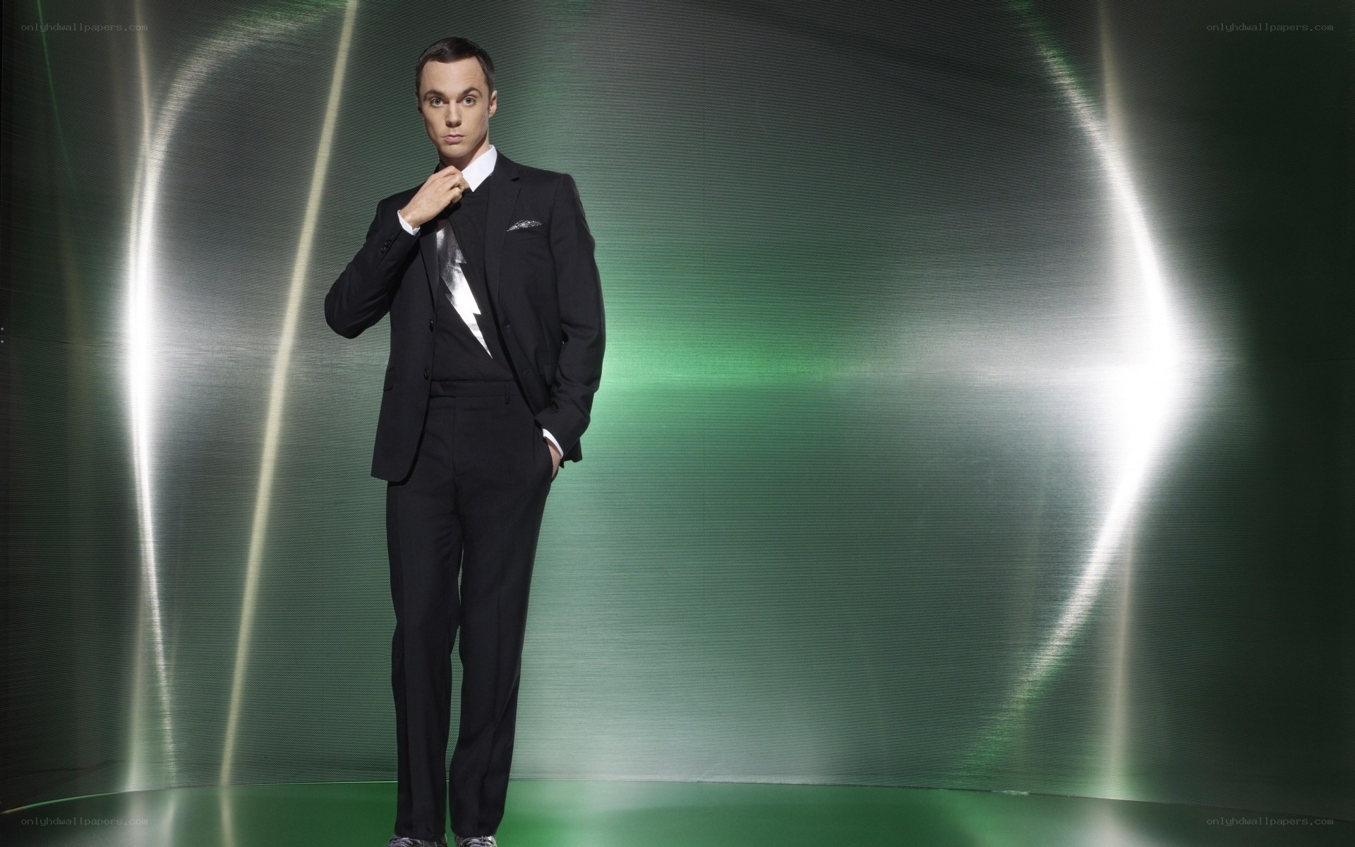 man in black suit adjusting tie