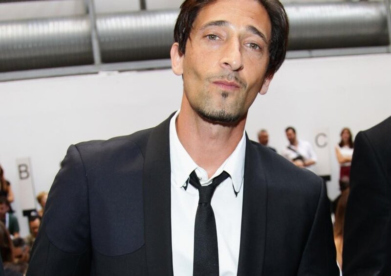 man in black suit at event