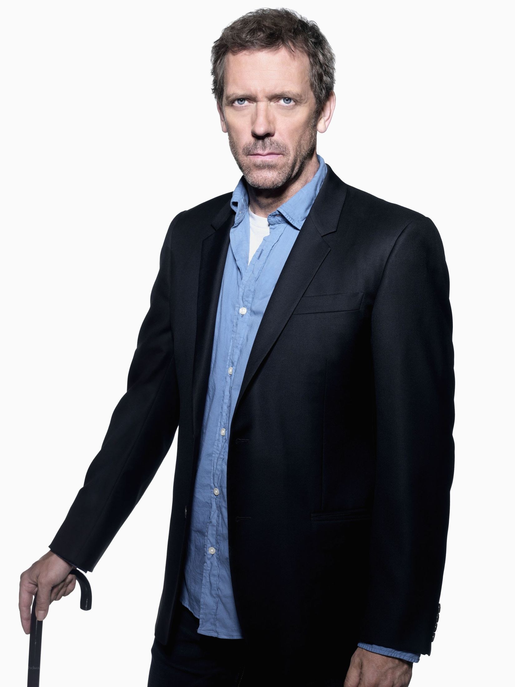 man in black suit holding cane