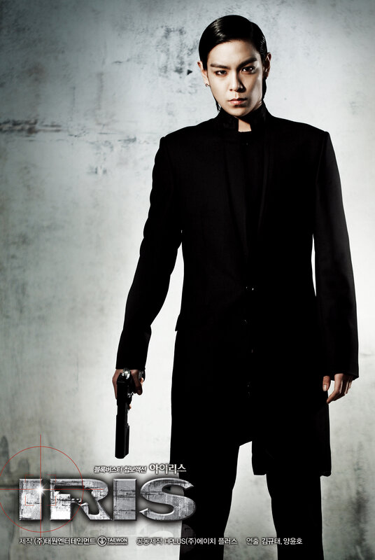 Man in black suit holding gun