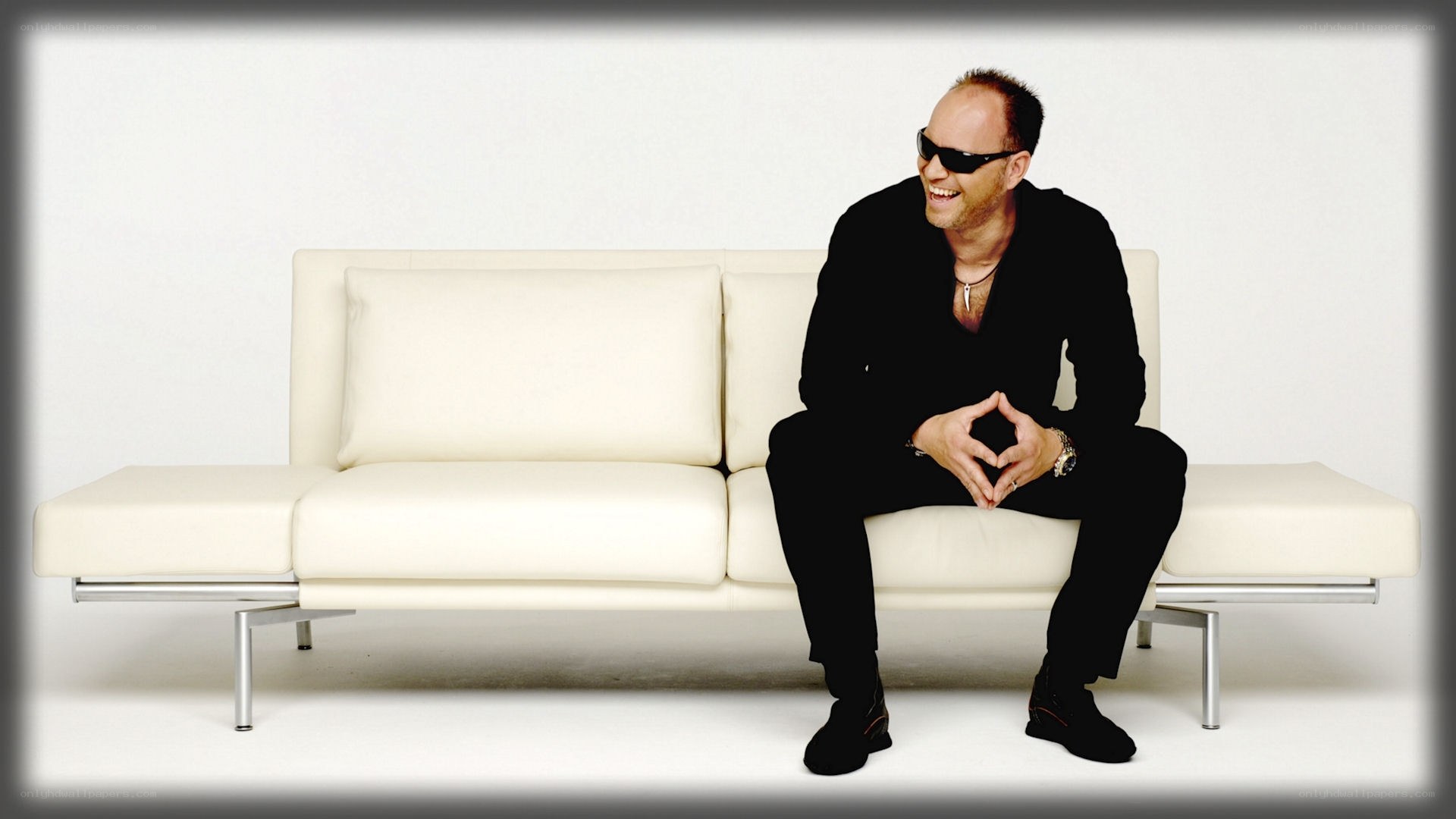 man in black suit on white couch