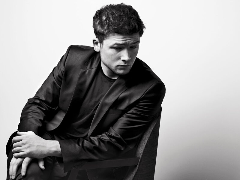 Man in Black Suit — Serious, Photograph, Chair, White Background