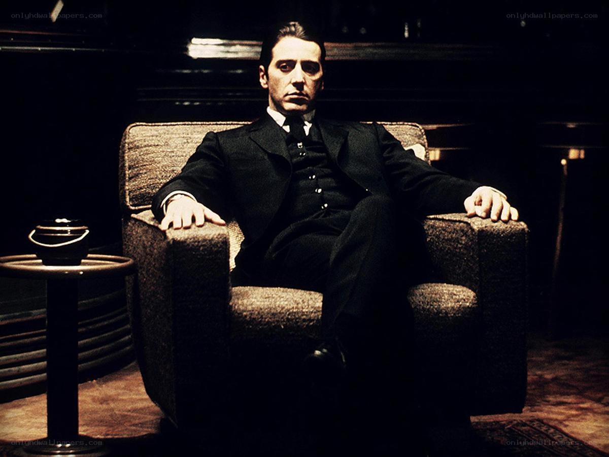 man in black suit sitting