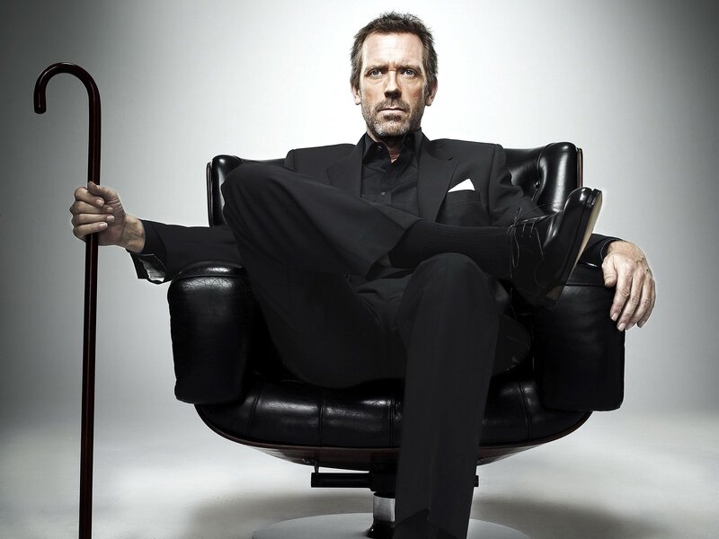 man in black suit sitting