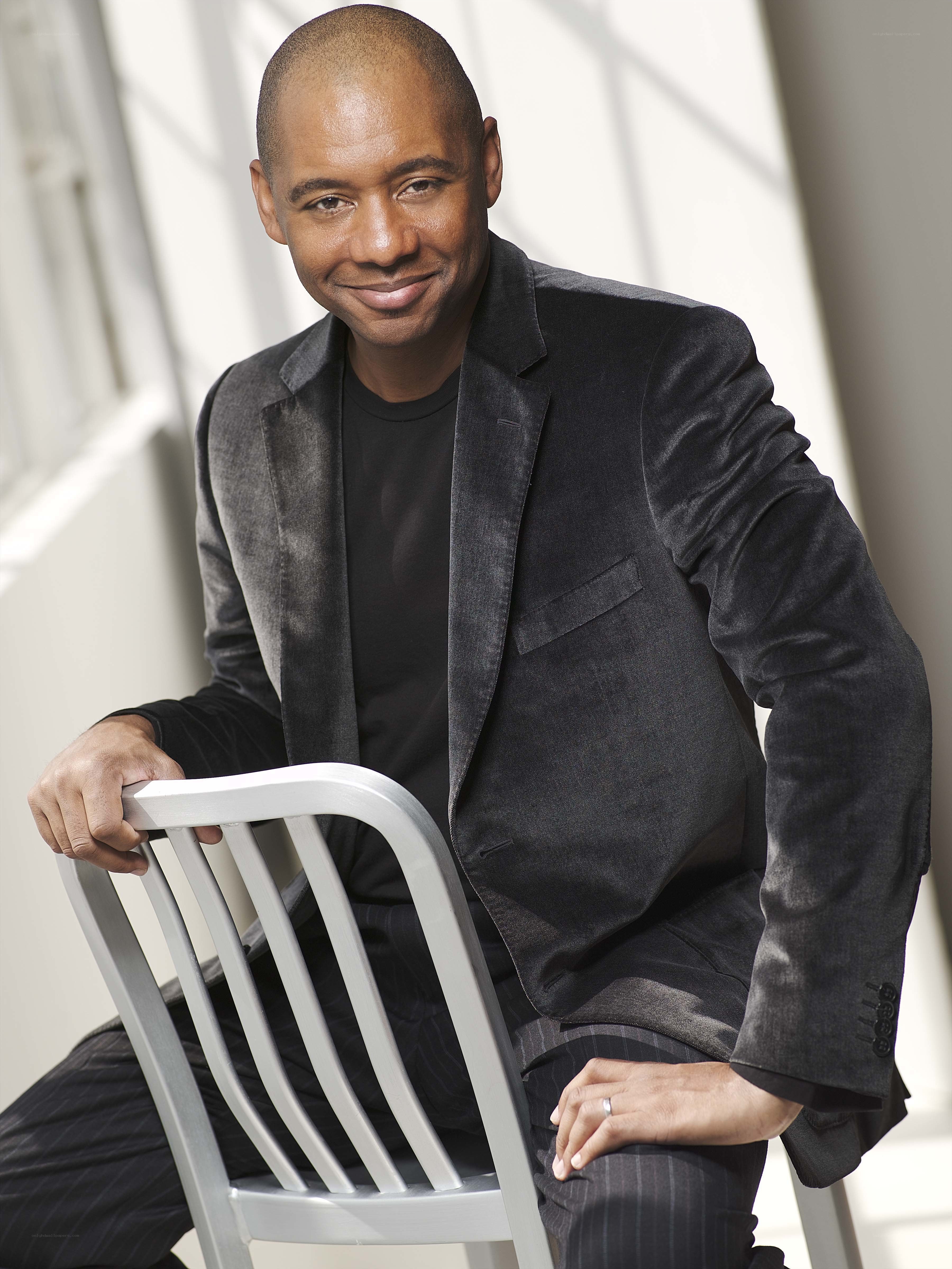 man in black suit sitting