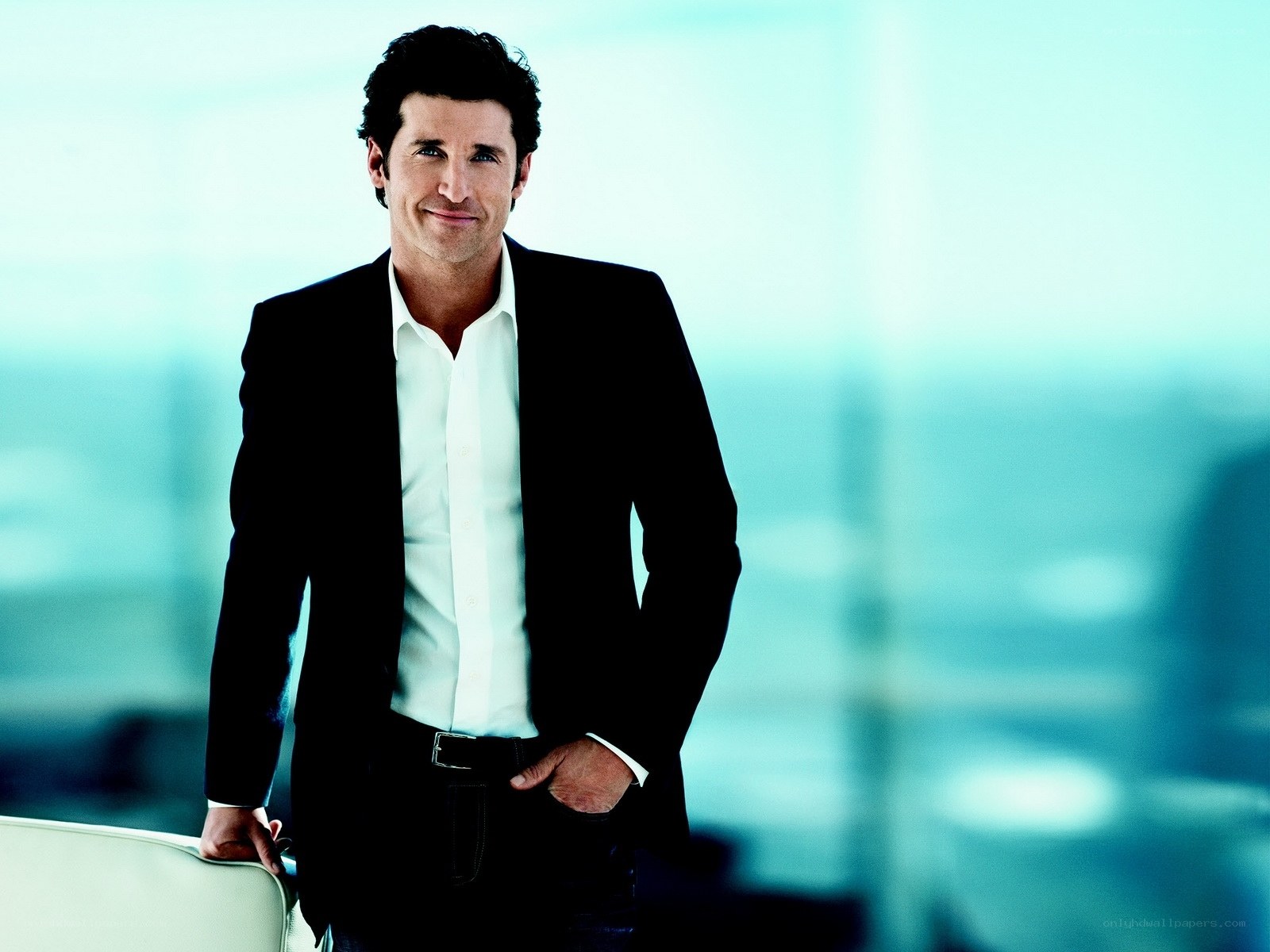 man in black suit smiling