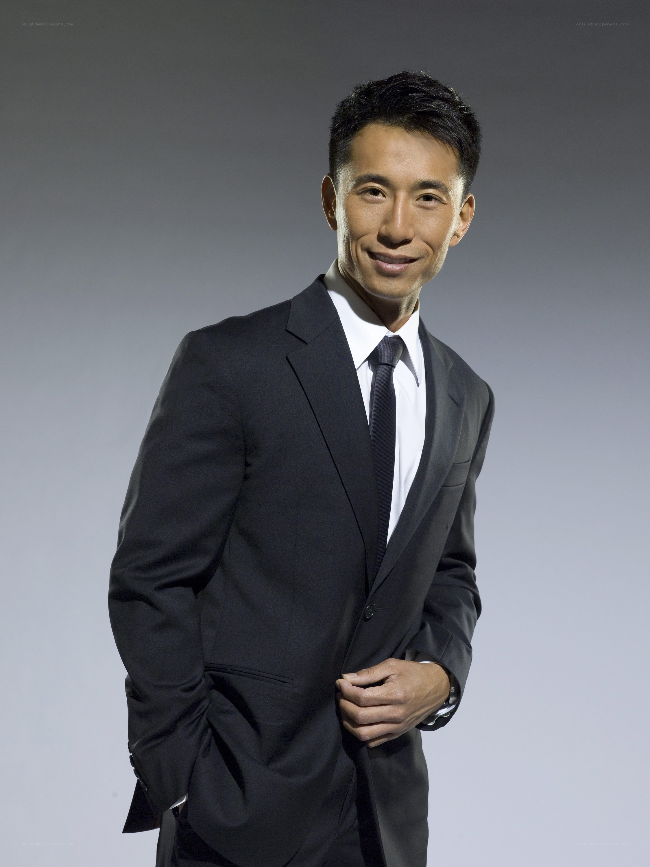 man in black suit smiling