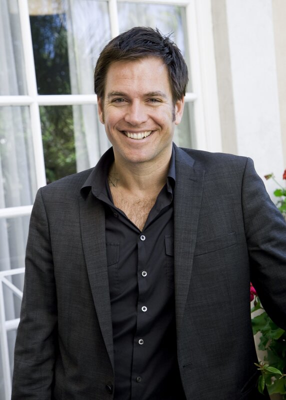 man in black suit smiling