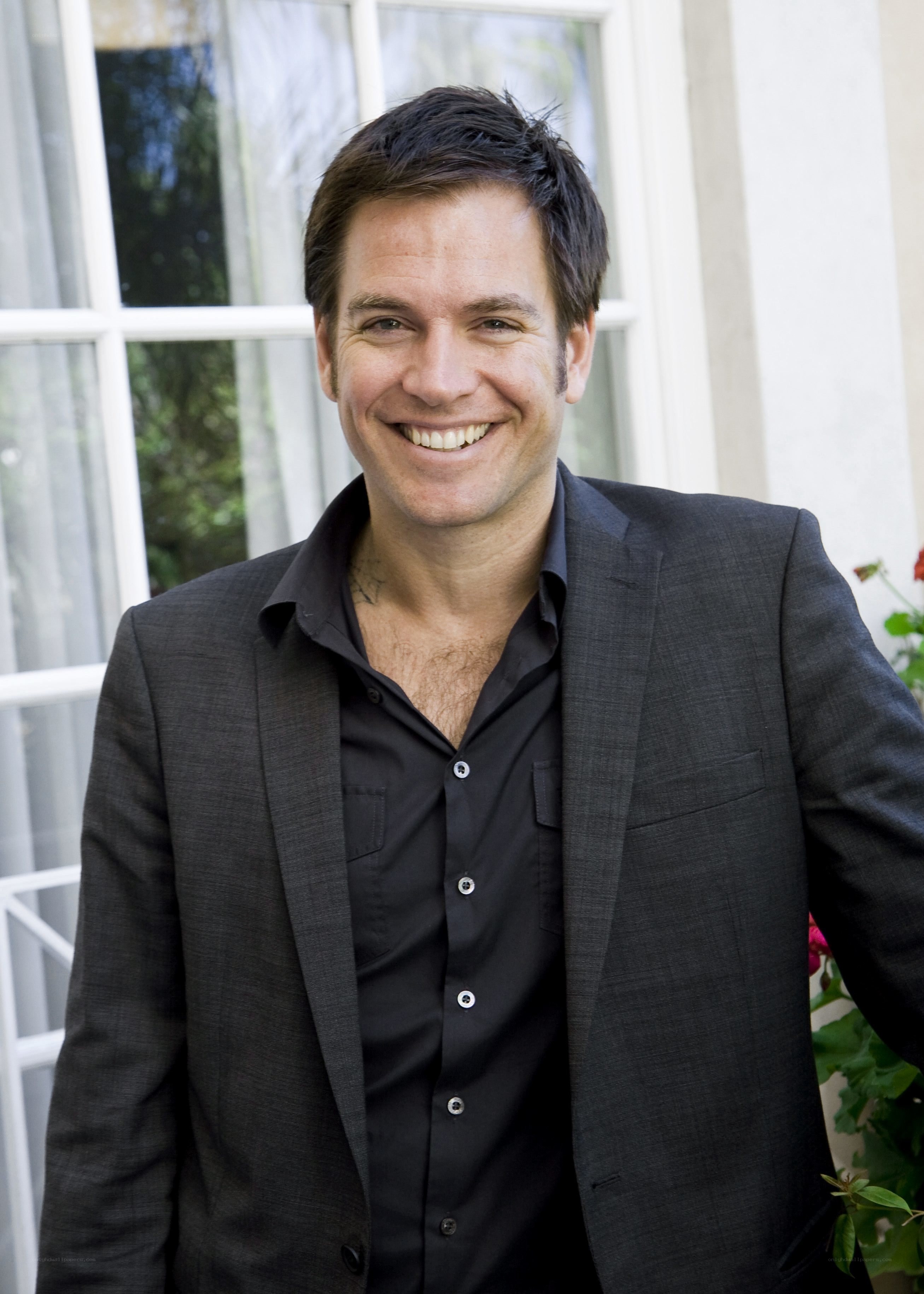 man in black suit smiling