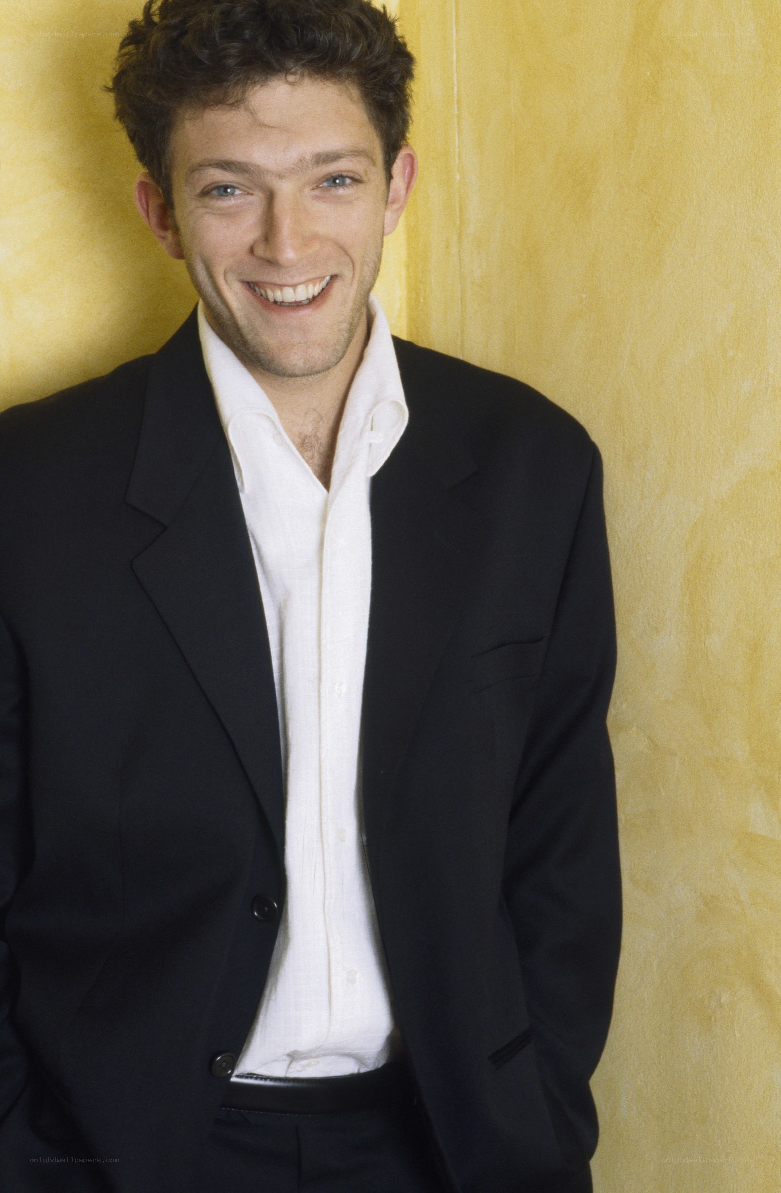 man in black suit smiling