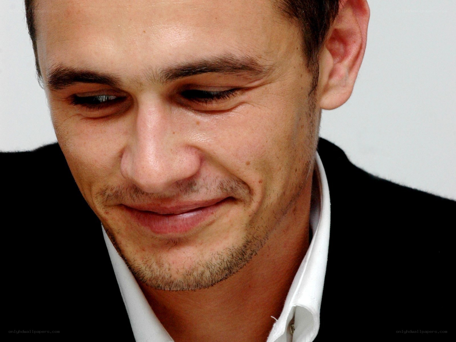 man in black suit smiling