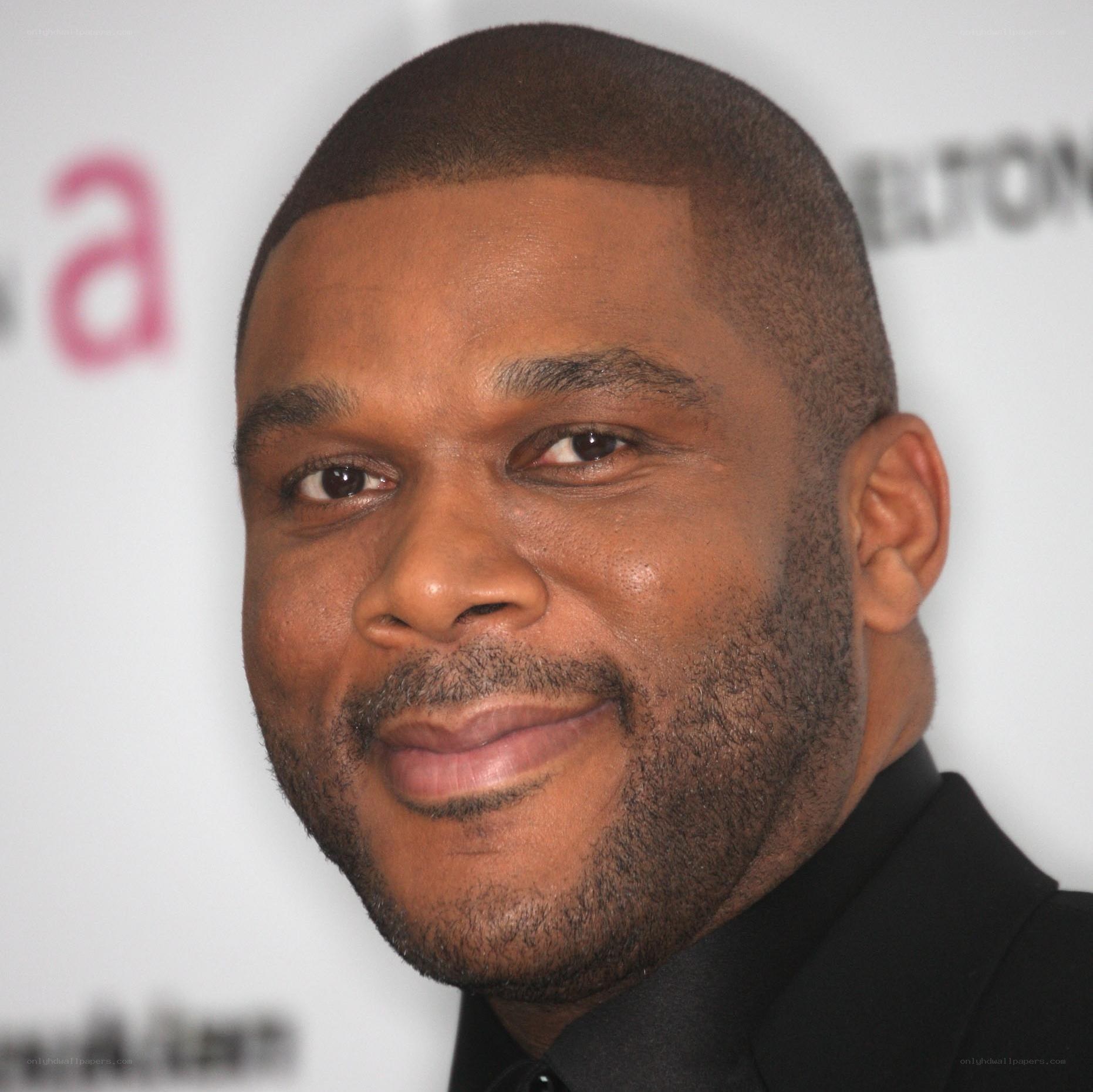 man in black suit smiling
